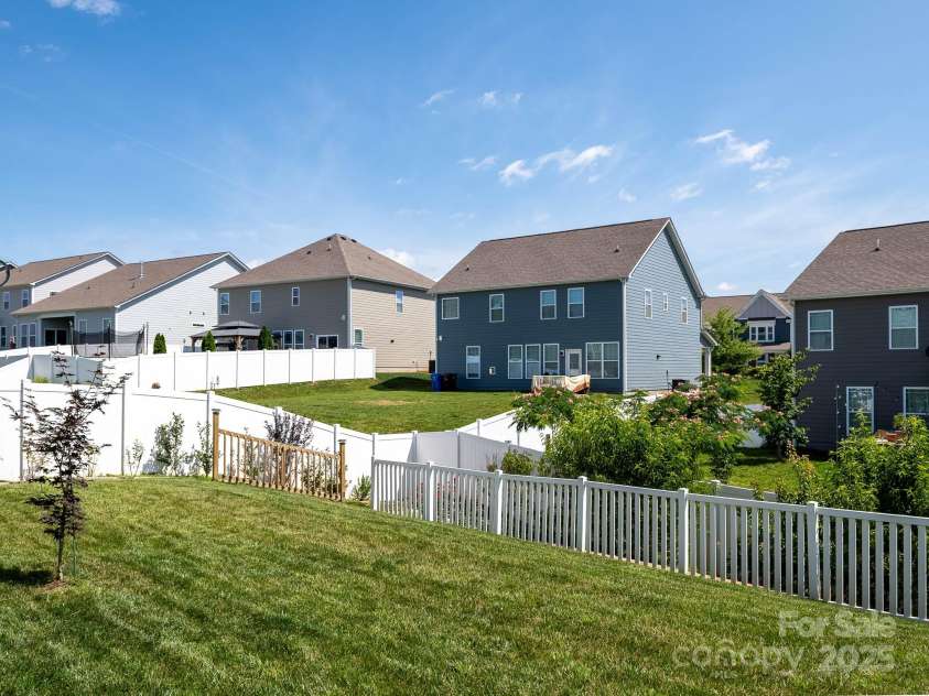 170 Atwater Landing Drive, Mooresville, NC 28117.  MLS# CAR4249384, YatesRealty ID 28180. Yard extends beyond four foot open fencing to privacy fence in rear with stairs to lower level of yard.