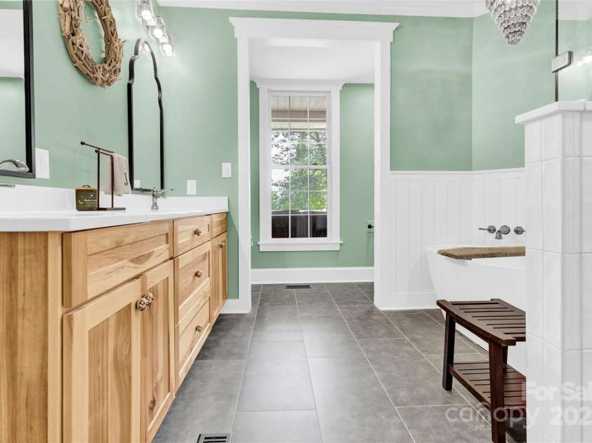 832 Kemp Road, Mooresville, NC 28117.  MLS# CAR4264266, YatesRealty ID 28181. Primary Bathroom with stand alone soaking tub and tiled shower.