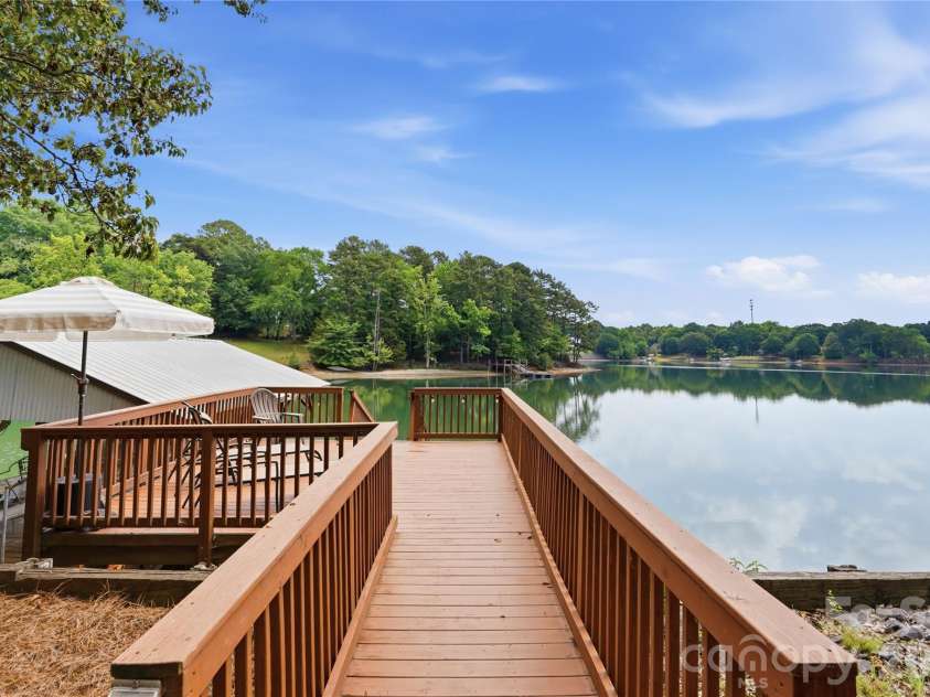 1113 Palmyra Drive, Tega Cay, SC 29708.  MLS# CAR4379735, YatesRealty ID 28182. Lakeside deck and a covered dock with lift plus floating dock provide direct access to Lake Wylie.