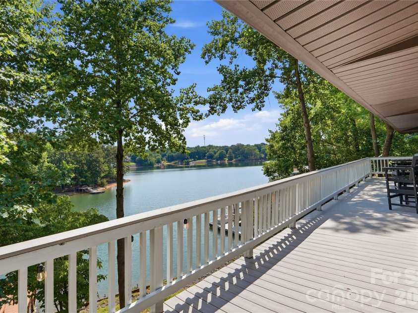 1113 Palmyra Drive, Tega Cay, SC 29708.  MLS# CAR4379735, YatesRealty ID 28182. Take in the glorious lake views from your spacious partially covered deck