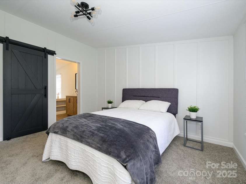 4833 Verde View Drive, Gastonia, NC 28056.  MLS# CAR4276387, YatesRealty ID 28190. Another view of primary bedroom with barn door to primary bath suite.