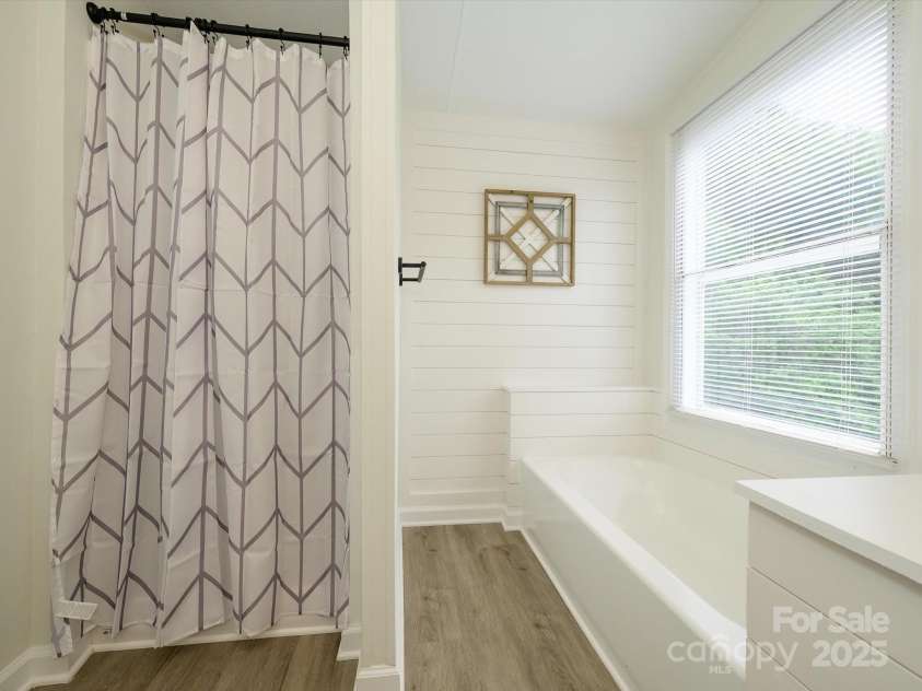 4833 Verde View Drive, Gastonia, NC 28056.  MLS# CAR4276387, YatesRealty ID 28190. Closer view of shower and bath tub surrounded by ship lap.