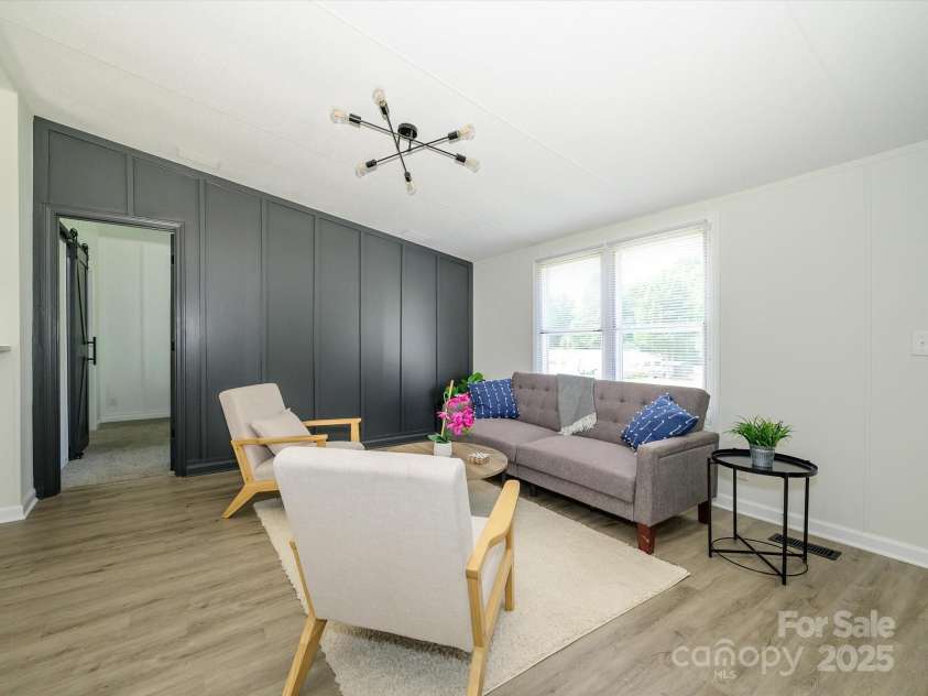 4833 Verde View Drive, Gastonia, NC 28056.  MLS# CAR4276387, YatesRealty ID 28190. View of Family room with new luxury vinyl plank flooring to front wall of home.