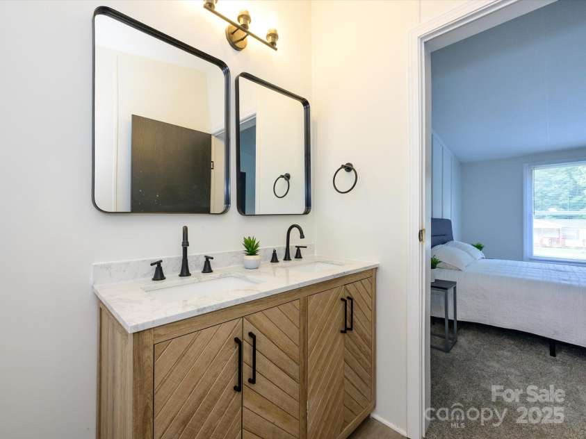 4833 Verde View Drive, Gastonia, NC 28056.  MLS# CAR4276387, YatesRealty ID 28190. View of primary bath vanity looking out into primary bedroom.