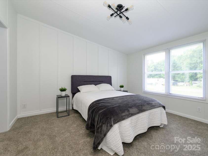 4833 Verde View Drive, Gastonia, NC 28056.  MLS# CAR4276387, YatesRealty ID 28190. View of primary bedroom with white board and batten wall behind headboard.