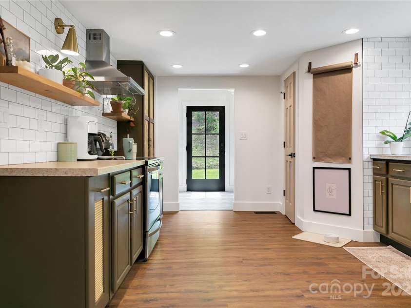 903 Middlefork Road, Brevard, NC 28712.  MLS# CAR4259647, YatesRealty ID 28206. Tile Backsplash w/Floating Shelves & Stainless Hood