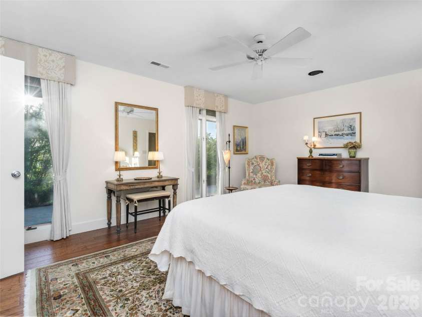 65 Crestwood Road, Asheville, NC 28804.  MLS# CAR4378966, YatesRealty ID 28211. This inviting bedroom features expansive windows, soft natural light, and tranquil views that create a calming escape.