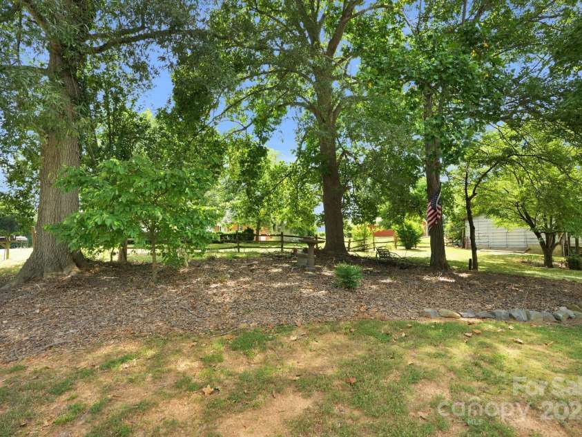 310 Culpepper Street, Monroe, NC 28112.  MLS# CAR4280006, YatesRealty ID 28213. Large wooded 1/2 acre lot