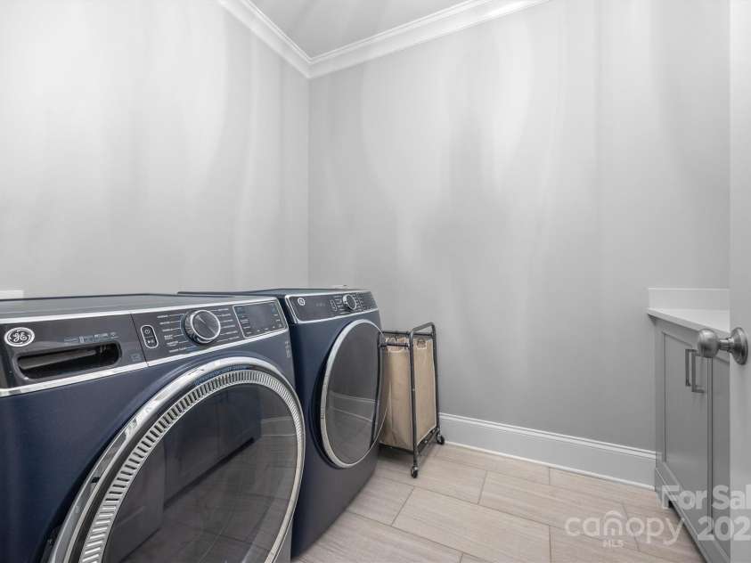 1223 Home Place, Matthews, NC 28105.  MLS# CAR4265332, YatesRealty ID 28217. Oversized Laundry Room includes cabinetry storage & wash sink.