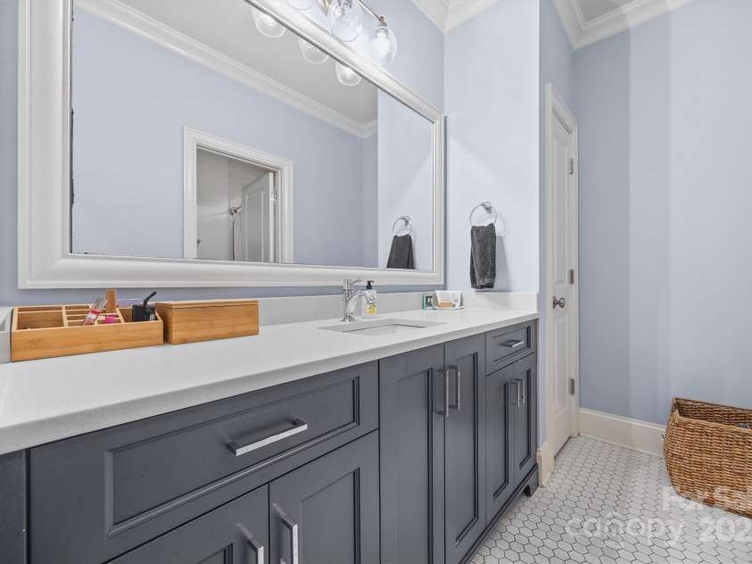 1223 Home Place, Matthews, NC 28105.  MLS# CAR4265332, YatesRealty ID 28217. Upstairs Bathroom 1 is a jack and jill setup with separate vanities for each attached bedroom, and a shared shower for 2 of the bedrooms.