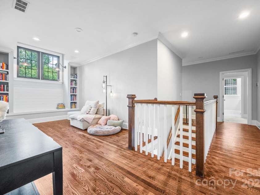 1223 Home Place, Matthews, NC 28105.  MLS# CAR4265332, YatesRealty ID 28217. Upstairs hallway features a cozy built-in reading nook.