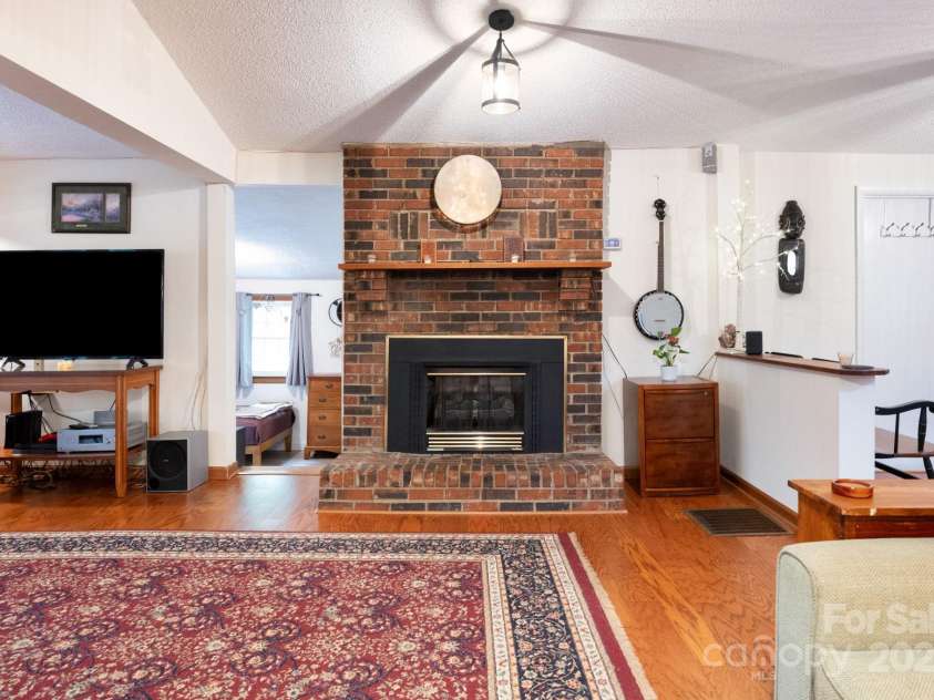 98 Mashburn Branch Road, Old Fort, NC 28762.  MLS# CAR4266767, YatesRealty ID 28229. Beautiful brick propane gas fireplace in spacious living room