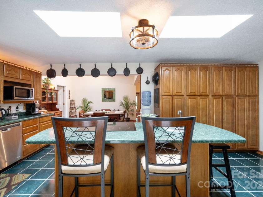 98 Mashburn Branch Road, Old Fort, NC 28762.  MLS# CAR4266767, YatesRealty ID 28229. Ceramic tile floors in the kitchen with a five-burner electric cooktop, stainless steel appliances