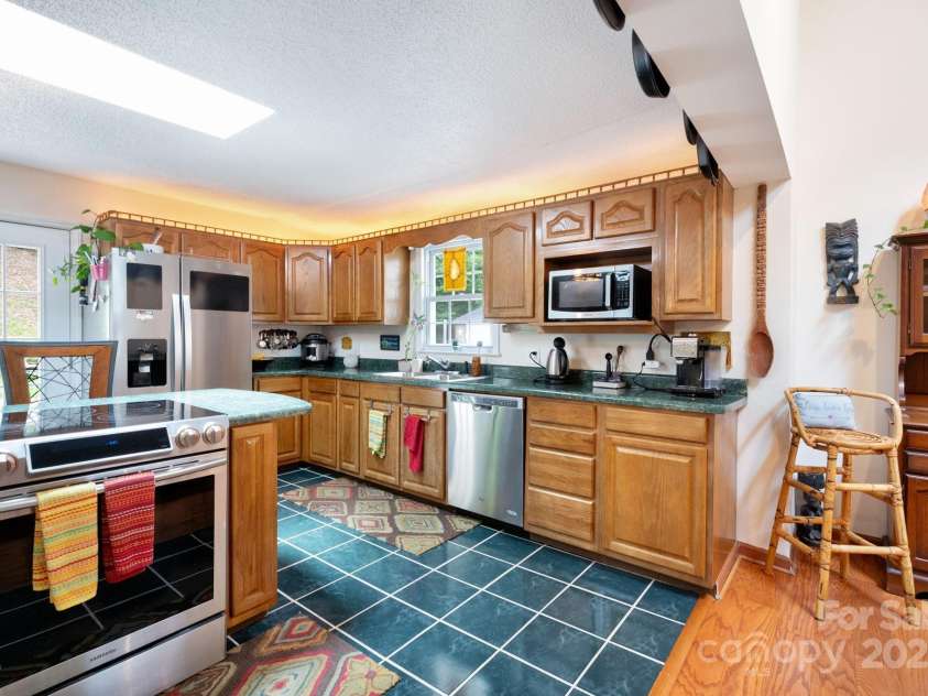 98 Mashburn Branch Road, Old Fort, NC 28762.  MLS# CAR4266767, YatesRealty ID 28229. Large functional kitchen with stainless appliances and breakfast bar