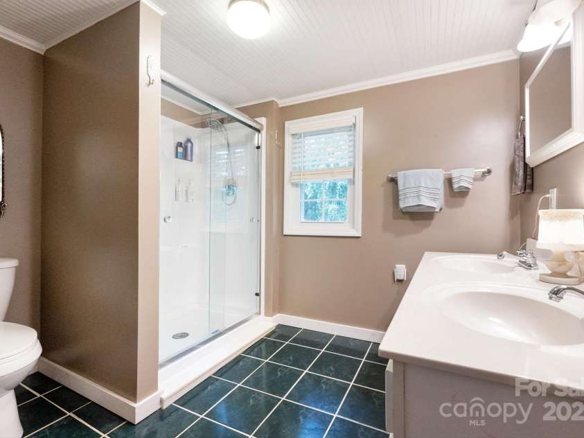 98 Mashburn Branch Road, Old Fort, NC 28762.  MLS# CAR4266767, YatesRealty ID 28229. Spacious Primary Bathroom with Huge Shower