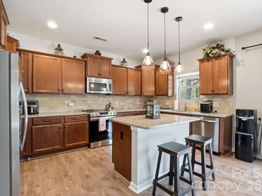 1231 Tranquil Falls Lane, Matthews, NC 28104.  MLS# CAR4390009, YatesRealty ID 28232. Kitchen with Granite Countertops