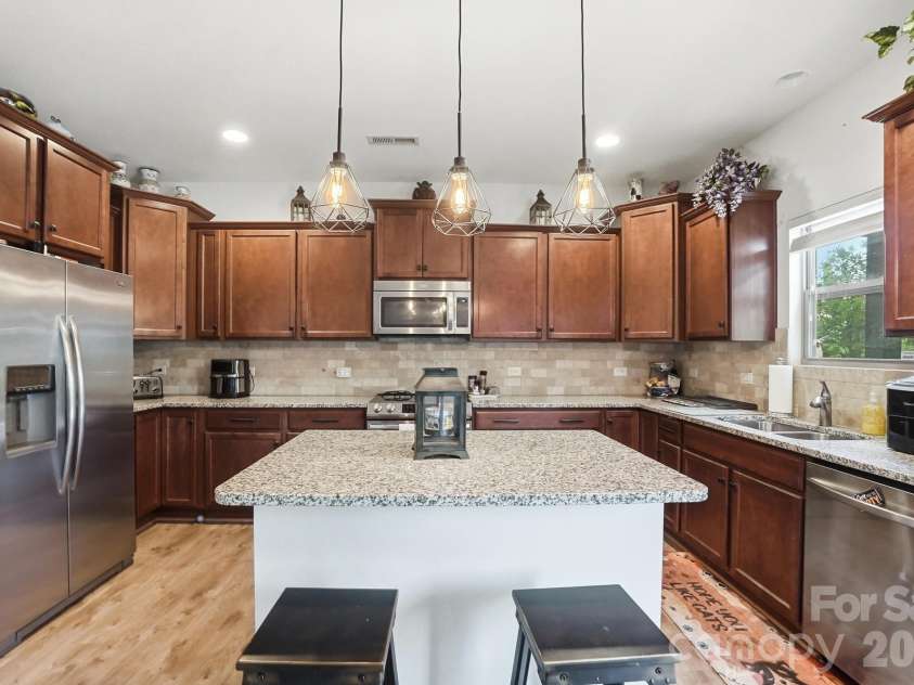 1231 Tranquil Falls Lane, Matthews, NC 28104.  MLS# CAR4390009, YatesRealty ID 28232. Kitchen with Granite Countertops