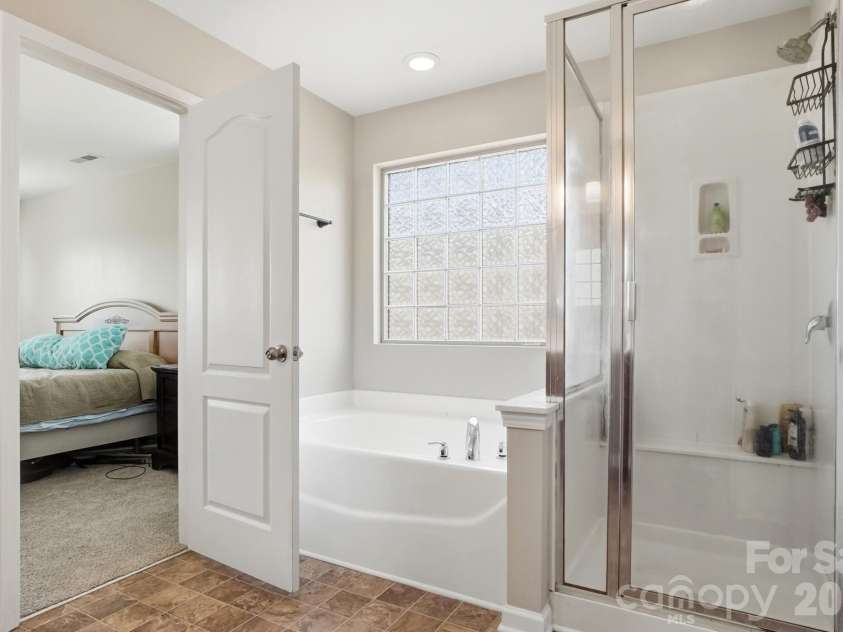 1231 Tranquil Falls Lane, Matthews, NC 28104.  MLS# CAR4390009, YatesRealty ID 28232. Primary Suite