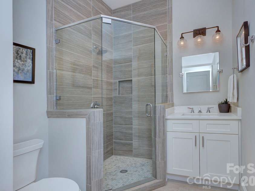 2109 Lanier Avenue, Charlotte, NC 28205.  MLS# CAR4389130, YatesRealty ID 28233. Main Level Bathroom with tile shower