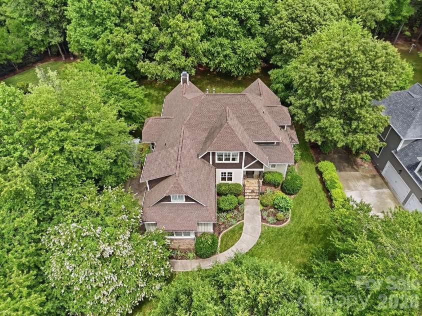 184 Ashmore Circle, Troutman, NC 28166.  MLS# CAR4384807, YatesRealty ID 28237. Bird's-eye view highlighting the generous backyard, wooded backdrop, and desirable lot position.