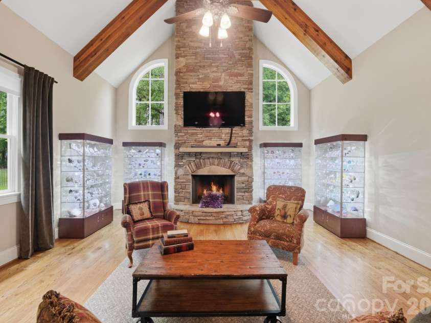 184 Ashmore Circle, Troutman, NC 28166.  MLS# CAR4384807, YatesRealty ID 28237. Dramatic great room featuring soaring ceilings, exposed wood beams, and a floor-to-ceiling stone fireplace.