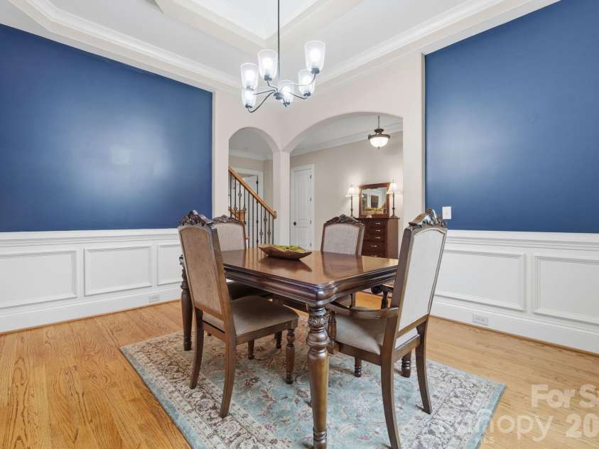 184 Ashmore Circle, Troutman, NC 28166.  MLS# CAR4384807, YatesRealty ID 28237. Elegant dining room highlighted by extensive millwork, tray ceiling, and striking designer accent walls.