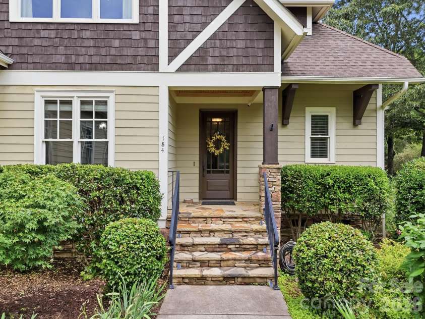 184 Ashmore Circle, Troutman, NC 28166.  MLS# CAR4384807, YatesRealty ID 28237. Inviting covered entry with stone accents and craftsman-inspired architectural details.