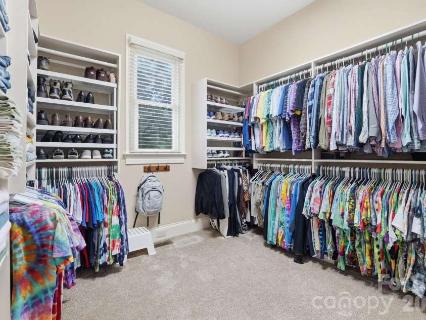 184 Ashmore Circle, Troutman, NC 28166.  MLS# CAR4384807, YatesRealty ID 28237. Large custom walk-in closet with extensive built-in storage, shelving, and organization.