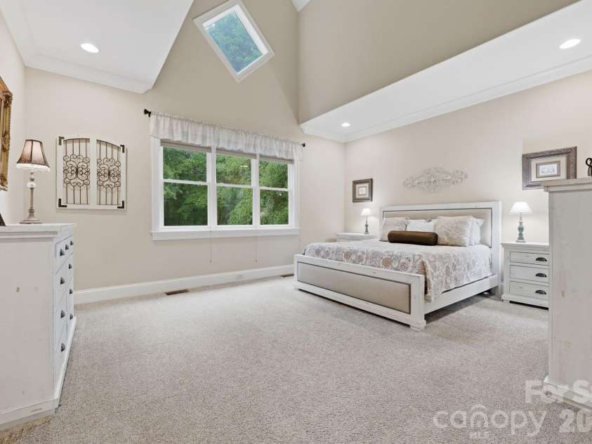 184 Ashmore Circle, Troutman, NC 28166.  MLS# CAR4384807, YatesRealty ID 28237. Spacious primary suite featuring soaring ceilings, abundant natural light, and room to unwind.
