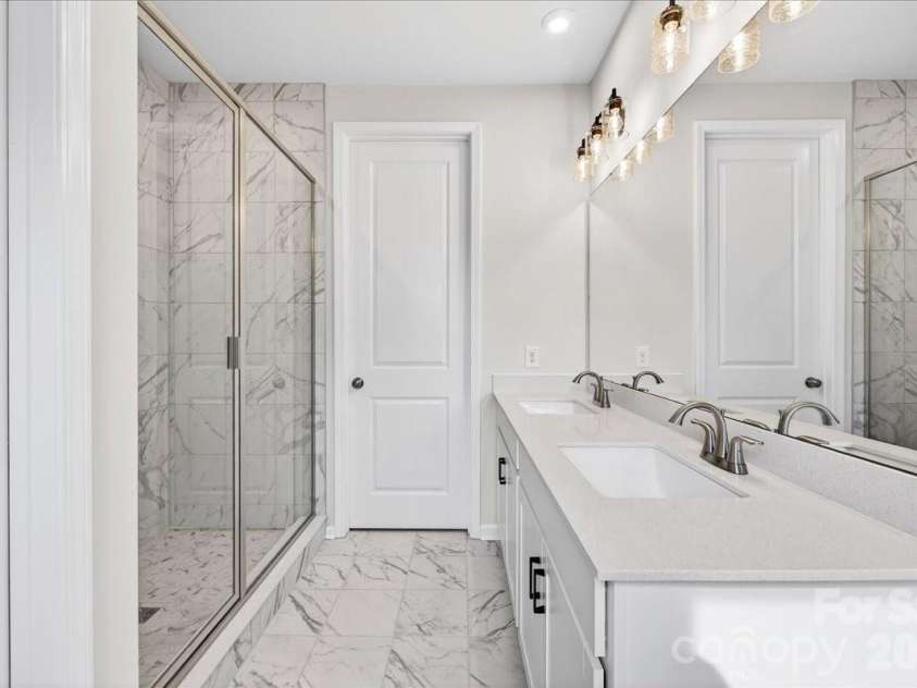 6053 Longar Lane, Charlotte, NC 28269.  MLS# CAR4368932, YatesRealty ID 28239. Dual vanity primary bathroom 