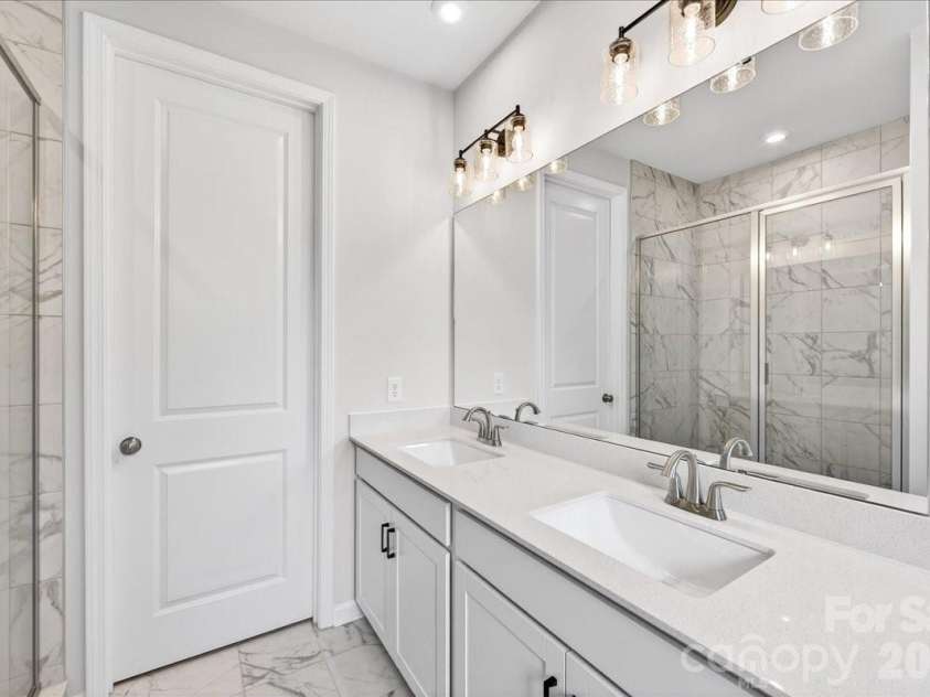6053 Longar Lane, Charlotte, NC 28269.  MLS# CAR4368932, YatesRealty ID 28239. Dual vanity primary bathroom 