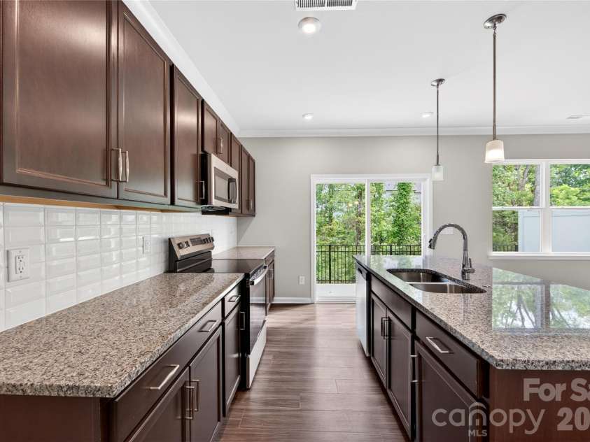 6021 Longar Lane, Charlotte, NC 28269.  MLS# CAR4376915, YatesRealty ID 28240. Electric oven range, microwave and dishwaher