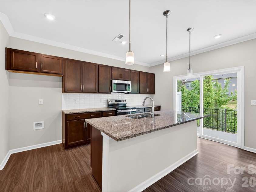 6021 Longar Lane, Charlotte, NC 28269.  MLS# CAR4376915, YatesRealty ID 28240. Large kitchen island
