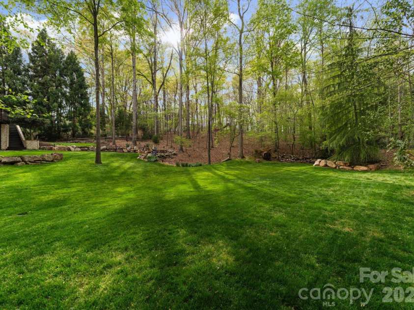 1514 Elmsford Lane, Matthews, NC 28105.  MLS# CAR4371432, YatesRealty ID 28254. Expansive lower level of backyard surrounded by additional green space