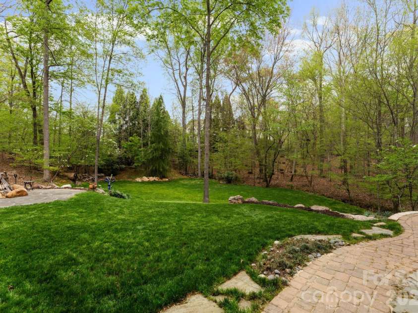 1514 Elmsford Lane, Matthews, NC 28105.  MLS# CAR4371432, YatesRealty ID 28254. Terraced backyard and surrounded by additional greenspace