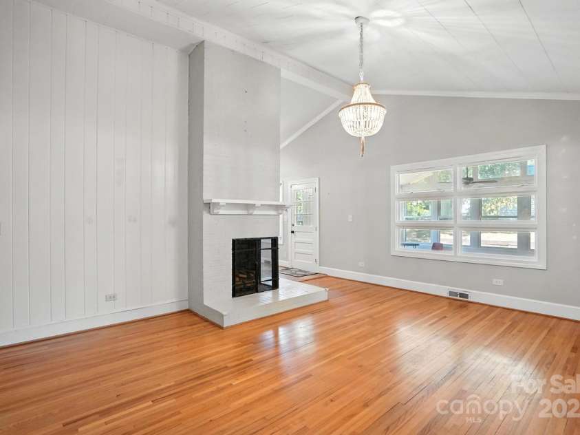 549 Spring Street, Concord, NC 28025.  MLS# CAR4284359, YatesRealty ID 28265. Beautiful living room with corner fireplace