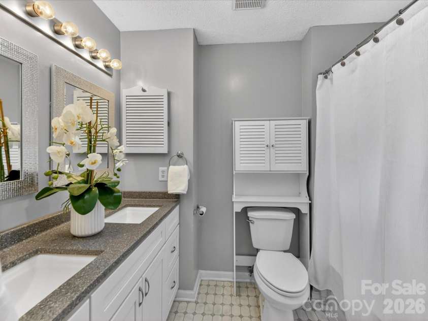 9518 Cedar River Road, Huntersville, NC 28078.  MLS# CAR4381514, YatesRealty ID 28268. Updated primary bathroom features dual vanities, modern finishes, and a functional layout designed to provide comfort, convenience, and a spa-like feel for everyday living.