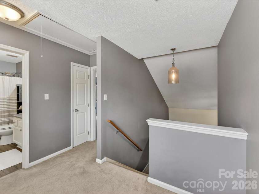 9518 Cedar River Road, Huntersville, NC 28078.  MLS# CAR4381514, YatesRealty ID 28268. Upper-level landing with neutral tones and updated lighting provides an open, airy transition between bedrooms while overlooking the home’s spacious main living areas.