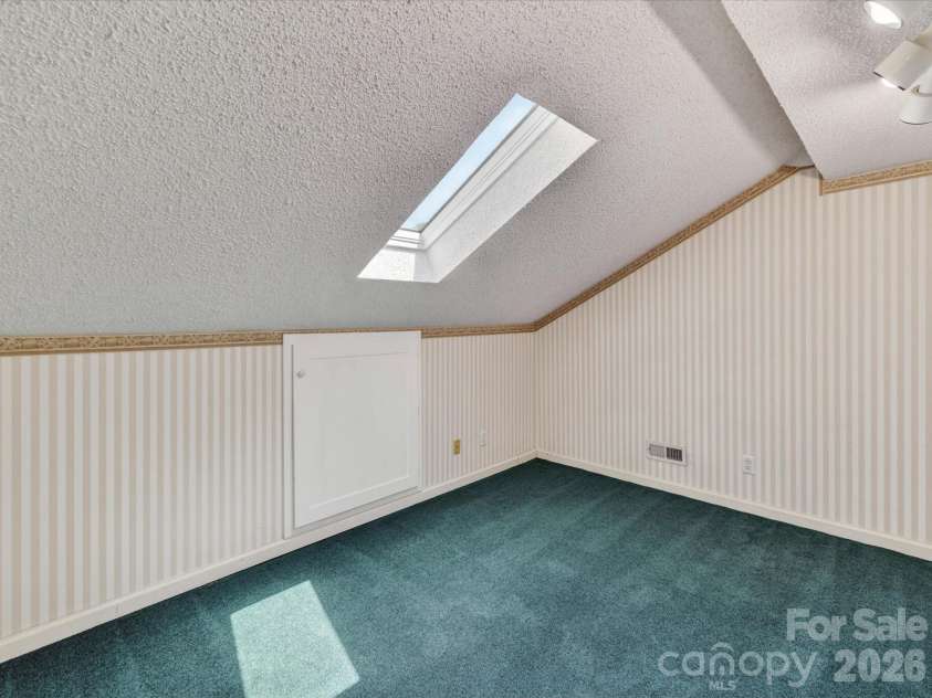 9518 Cedar River Road, Huntersville, NC 28078.  MLS# CAR4381514, YatesRealty ID 28268. Versatile flex space with skylight, unique architectural details, and built-in lighting offers endless possibilities for a home office, hobby room, playroom, or creative studio.
