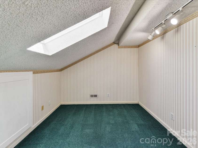 9518 Cedar River Road, Huntersville, NC 28078.  MLS# CAR4381514, YatesRealty ID 28268. Versatile flex space with skylight, unique architectural details, and built-in lighting offers endless possibilities for a home office, hobby room, playroom, or creative studio.