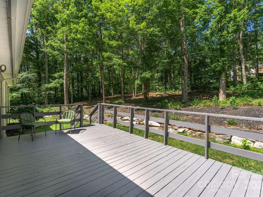 22 Glen Cove Road, Arden, NC 28704.  MLS# CAR4272199, YatesRealty ID 28269. The back yard has a stone wall that leads to a more level area.