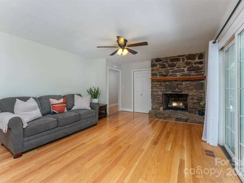 22 Glen Cove Road, Arden, NC 28704.  MLS# CAR4272199, YatesRealty ID 28269. The living room features a gas fireplace.