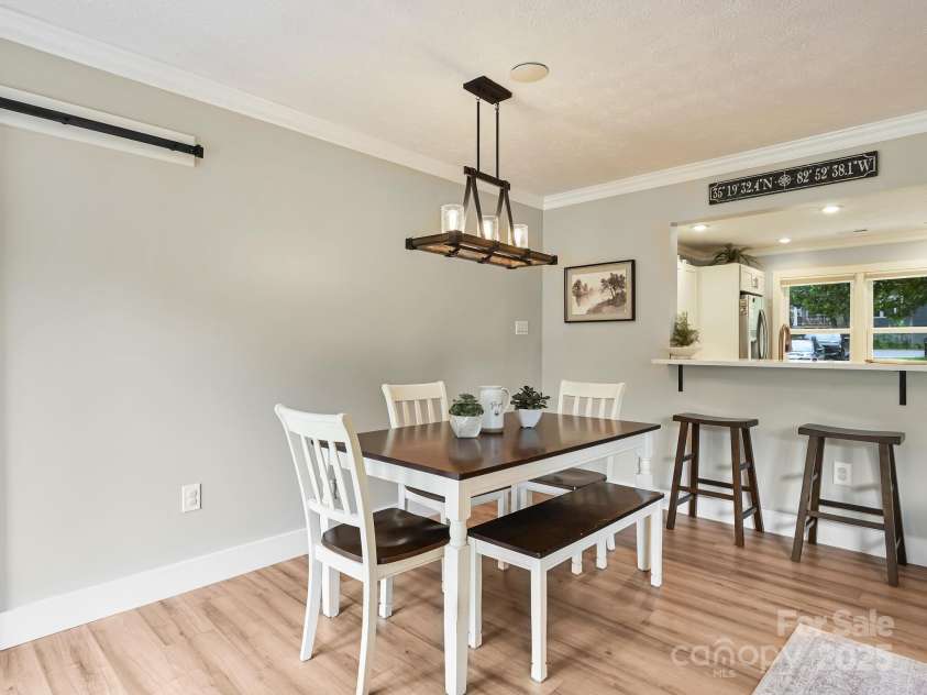 218 Blue Ridge Road, Black Mountain, NC 28711.  MLS# CAR4284698, YatesRealty ID 28276. Pass through and breakfast bar from kitchen to dining area