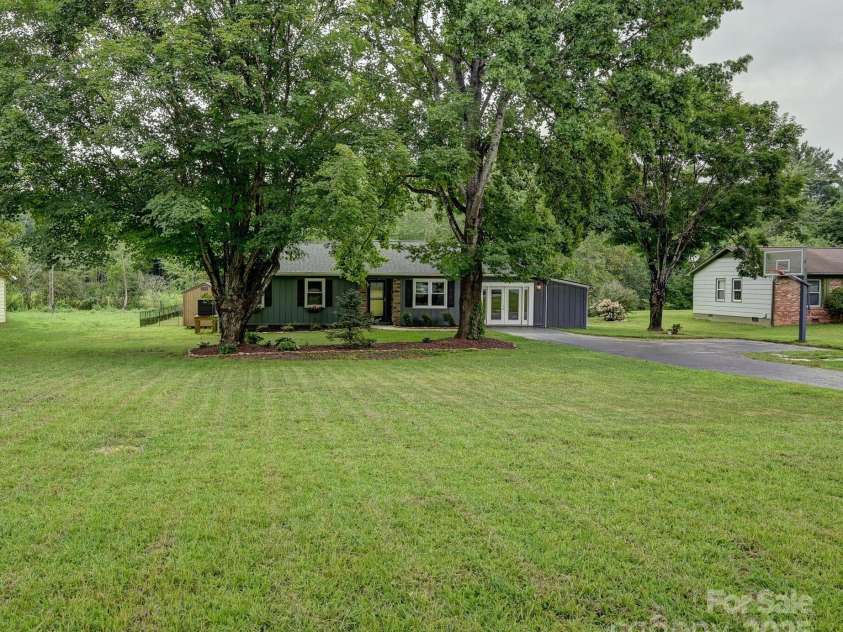 218 Blue Ridge Road, Black Mountain, NC 28711.  MLS# CAR4284698, YatesRealty ID 28276. Street view with a flat yard for parking and playing