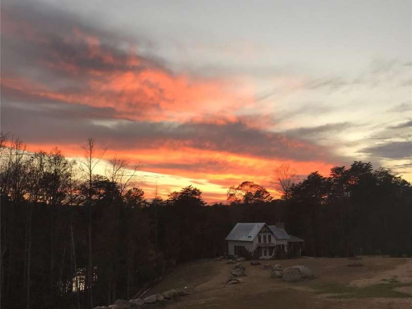 10016 St Kitts Landing Lane, Charlotte, NC 28278.  MLS# CAR4261578, YatesRealty ID 28282. Home owner sunset photo #1, lake shimmering through trees