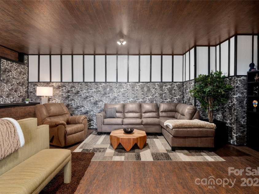 41 Ben Lippen School Road, Asheville, NC 28806.  MLS# CAR4316852, YatesRealty ID 28296. Basement level bedroom sitting area.