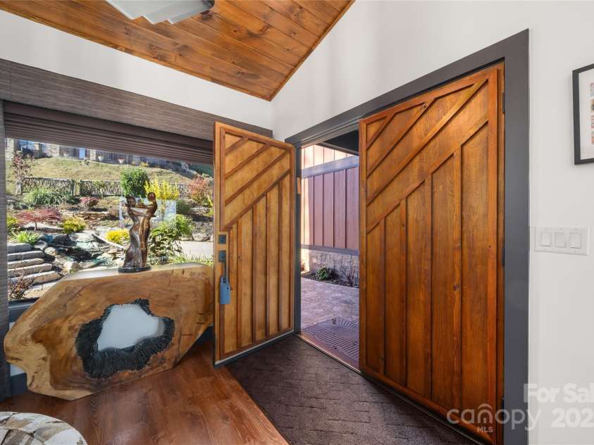 41 Ben Lippen School Road, Asheville, NC 28806.  MLS# CAR4316852, YatesRealty ID 28296. Beautiful water feature at covered entry with gorgeous landscaping.