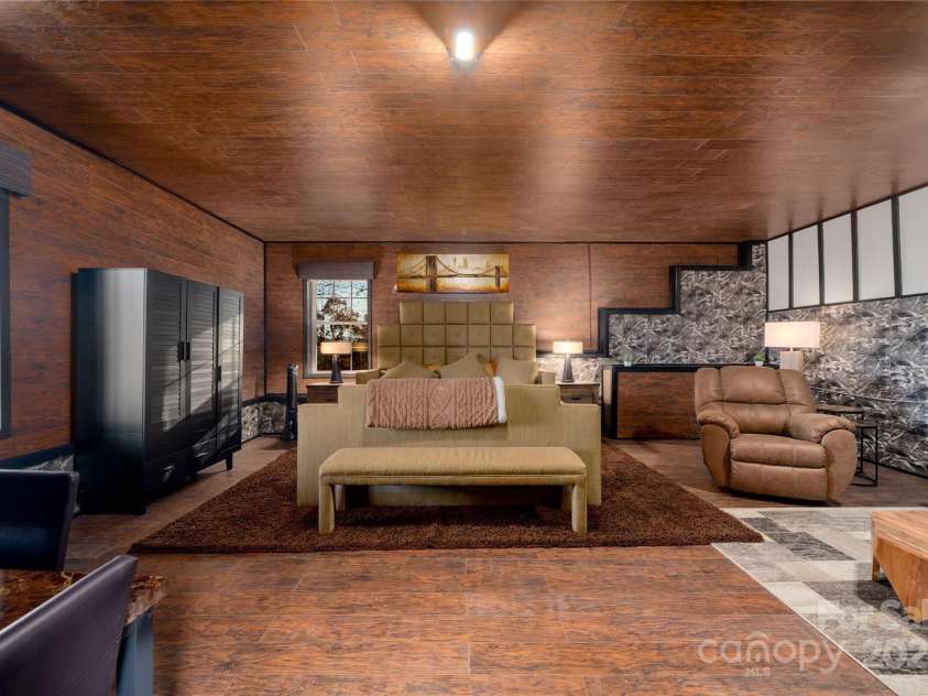 41 Ben Lippen School Road, Asheville, NC 28806.  MLS# CAR4316852, YatesRealty ID 28296. Bright basement level bedroom suite withe sitting area and views. 