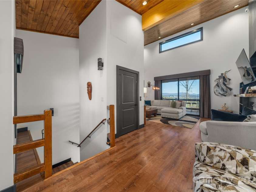 41 Ben Lippen School Road, Asheville, NC 28806.  MLS# CAR4316852, YatesRealty ID 28296. Extra wide stairway on left with sensor lighting leads to the lower level.