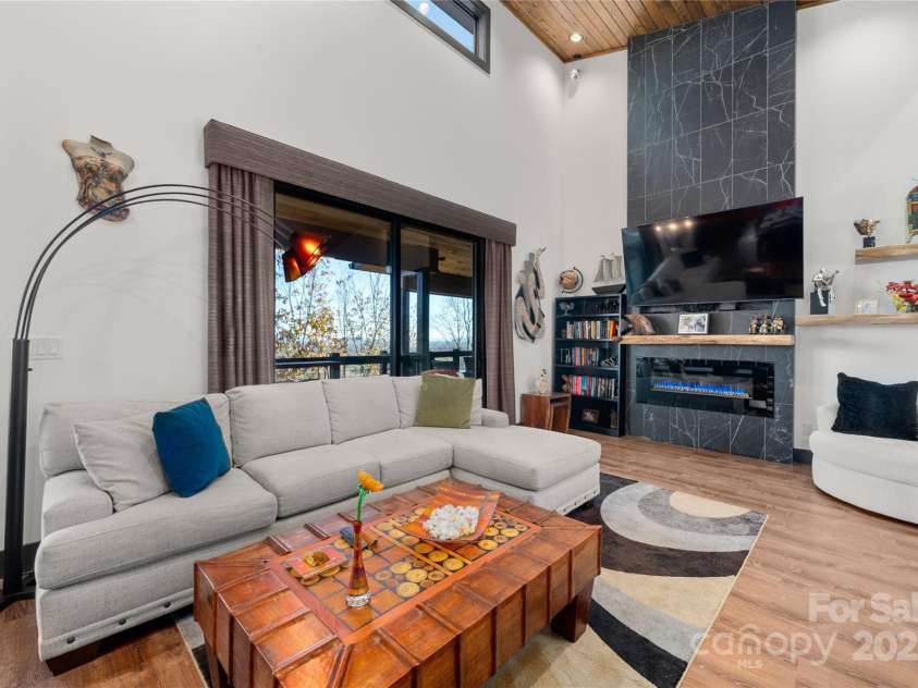 41 Ben Lippen School Road, Asheville, NC 28806.  MLS# CAR4316852, YatesRealty ID 28296. Great room with soaring pine ceilings and cozy fireplace 